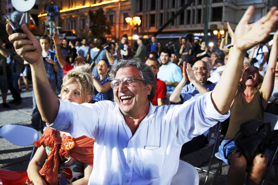 Voters celebrate the results of the referendum in Athens after a decisive majority rejected more austerity. Photo: Reuters