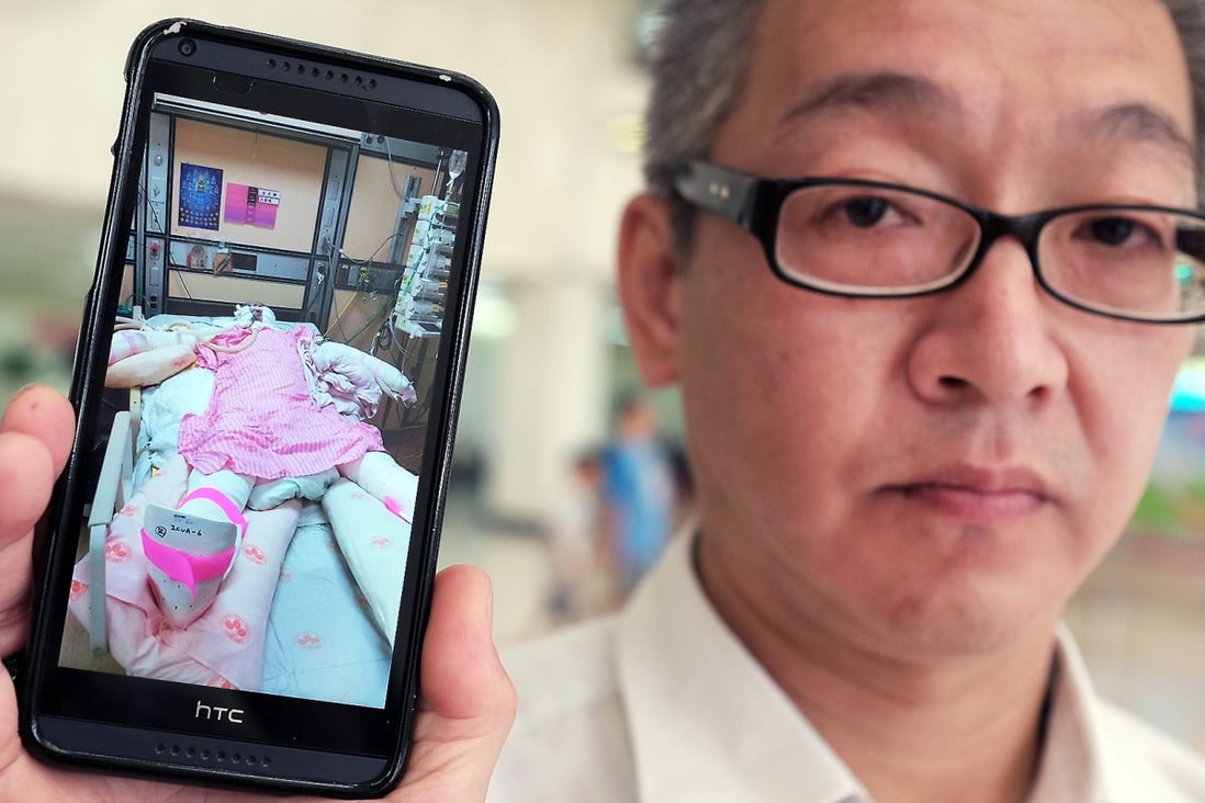 Michael Chu displays an image of his 18-year-old daughter, Julie, at a hospital in Taipei. Julie suffered burns to more than 70 per cent of her body in the water park explosion. Photo: AFP