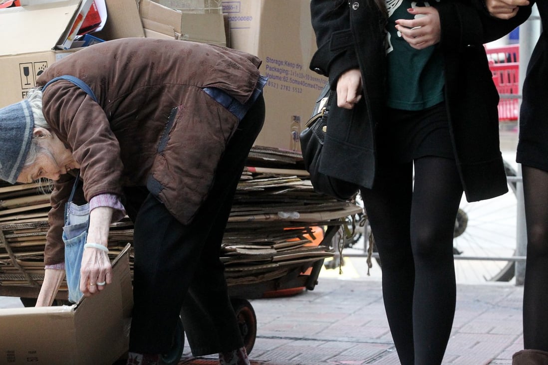 An old woman collects cardboard for cash in Causeway Bay. Photo: K. Y. Cheng
