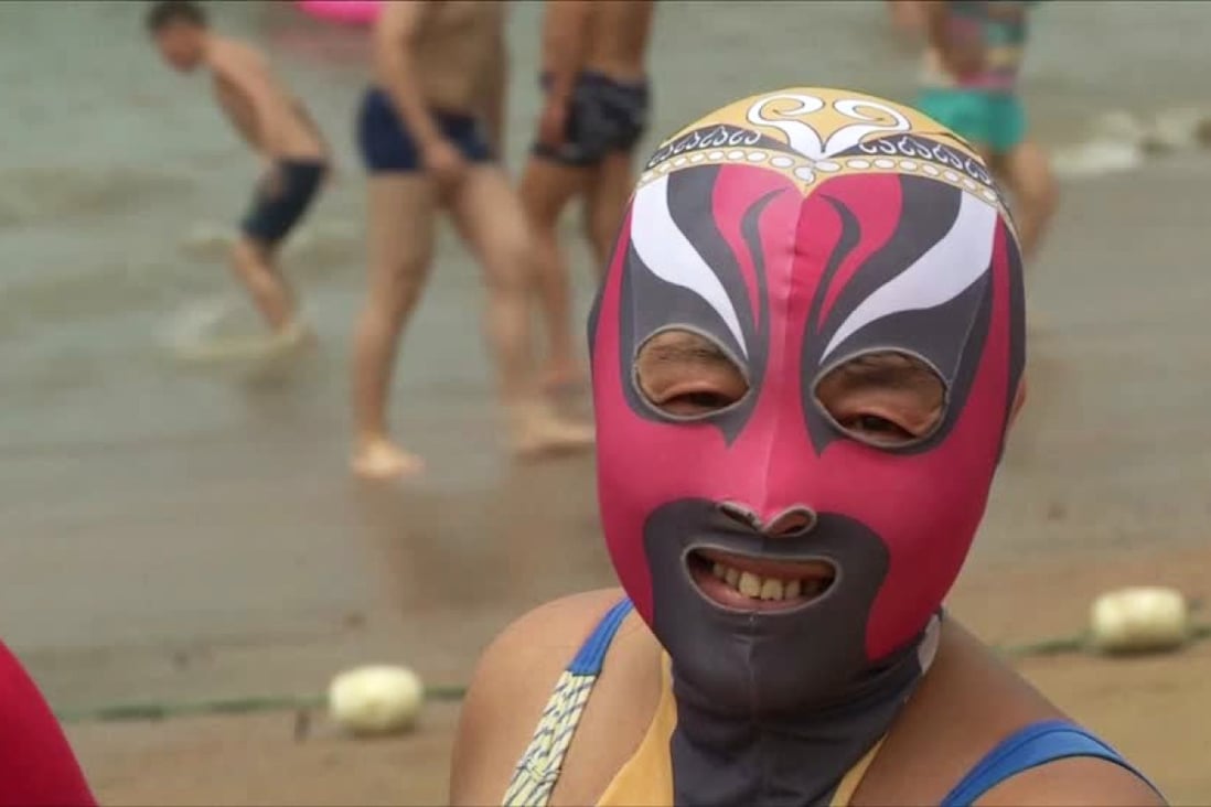 The face-kini mask is worn by many in China to protect them from the sun and jelly fish stings. Photo: Reuters