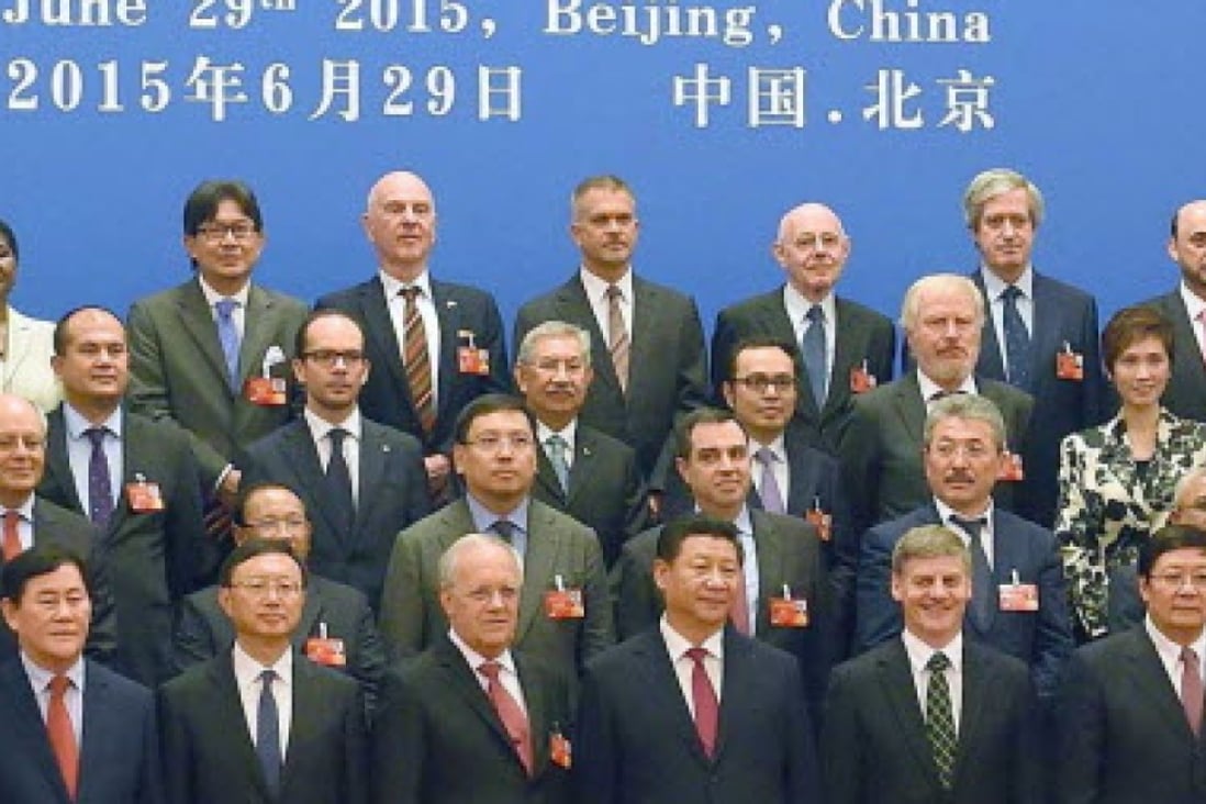 President Xi Jinping (bottom row, fourth left) and other AIIB delegates, some from countries that are sceptical of China's leadership in the venture. Photo: Kyodo