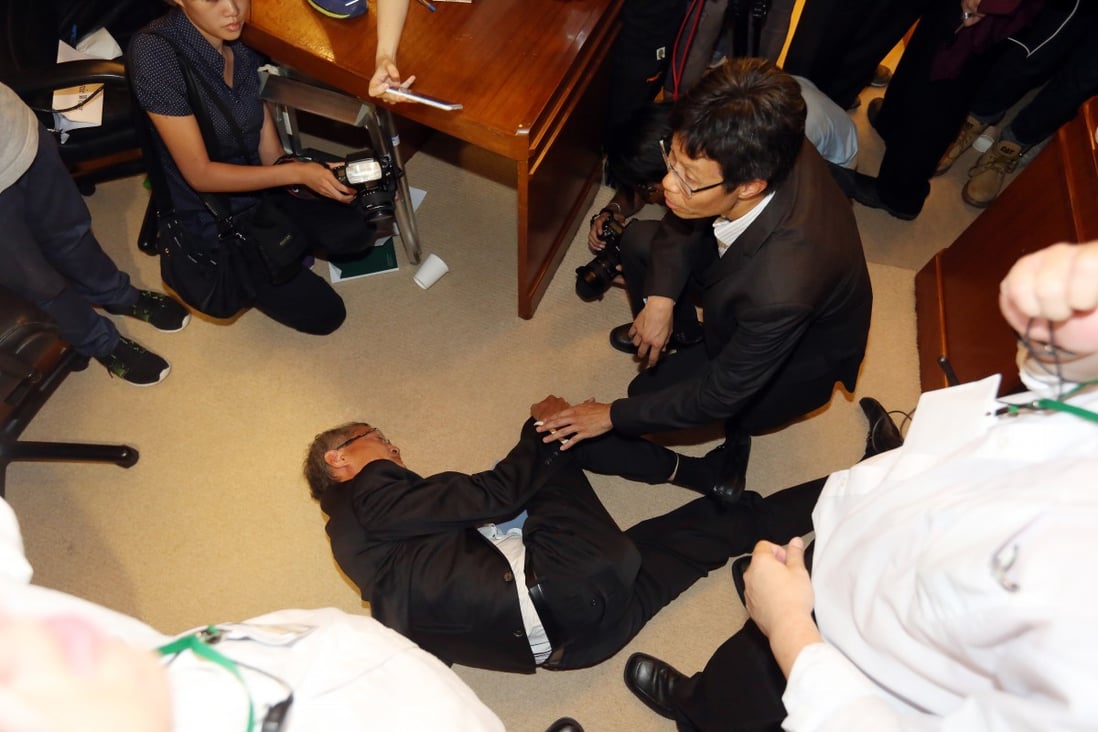 Images of council member Professor Lo Chung-mau falling to the ground became a meme this week when he denied "diving" like a cheating football player outside of a council meeting. Photo: SCMP Pictures 