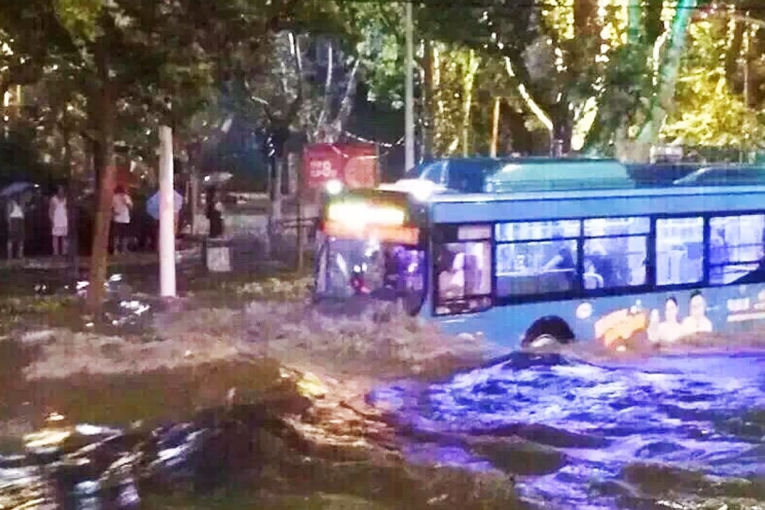 A bus ploughs its way through floodwater in Jinan. Photo: SCMP Pictures