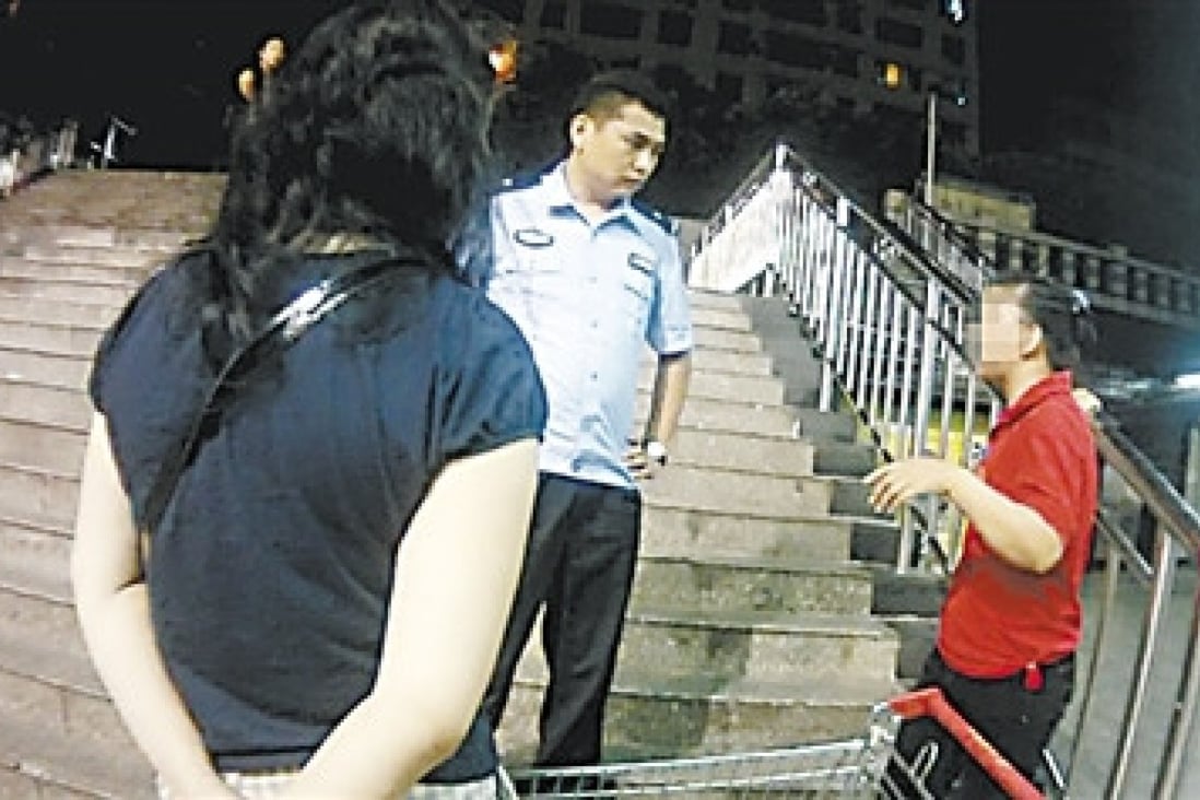 The mother, right, is cautioned for taking photos of supermarket employees without their permission. Photo: SCMP Pictures