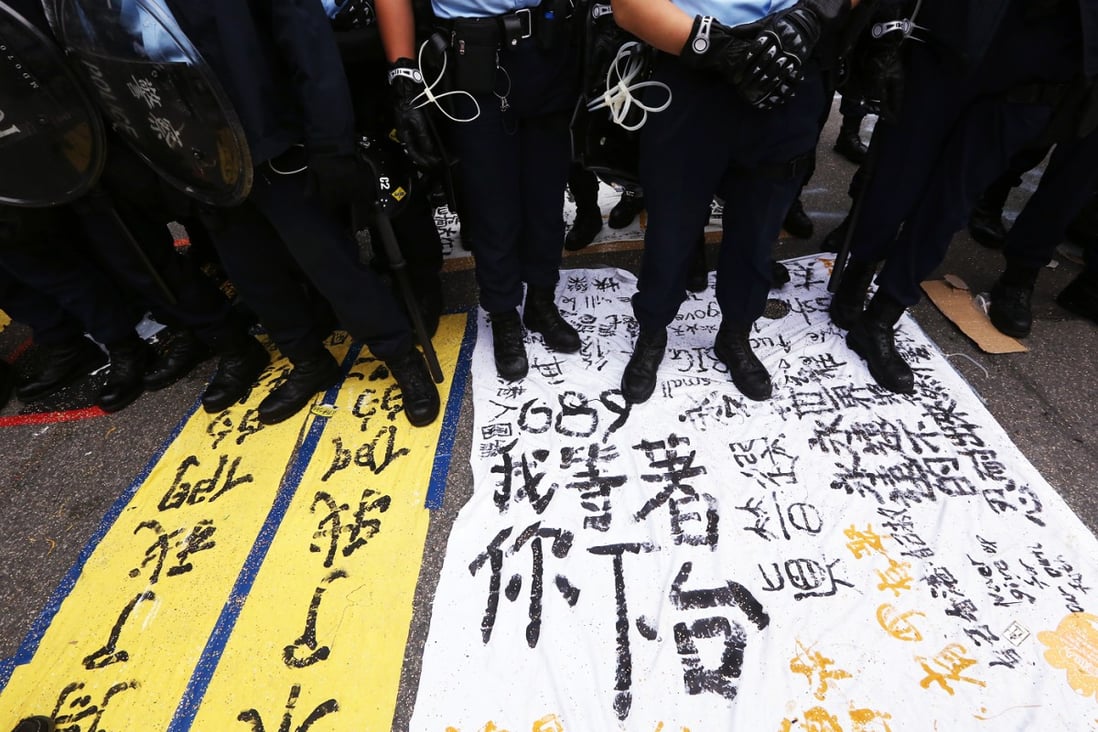 Police stand guard at aa protest site in Admiralty during the Occupy Movement in late 2014.Photo: Felix Wong