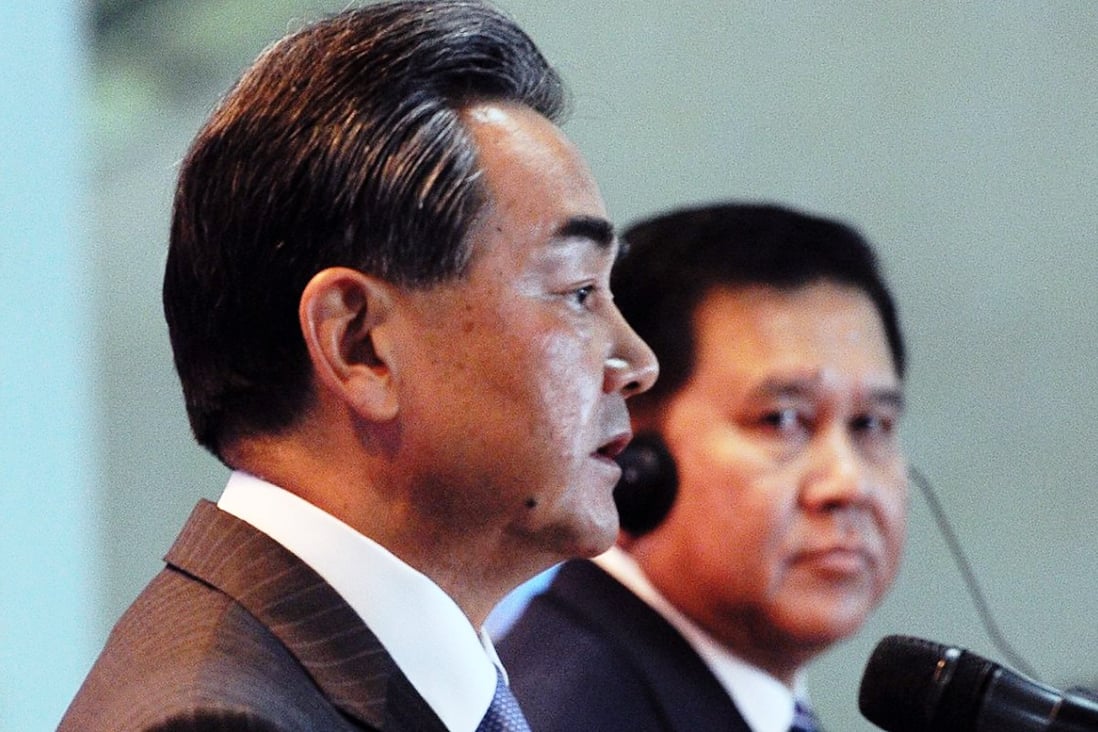 Must be love: China's Foreign Minister Wang Yi speaks in Kuala Lumpur as Thailand's Foreign Minister Tanasak Patimapragorn looks at him attentively.  Photo: EPA