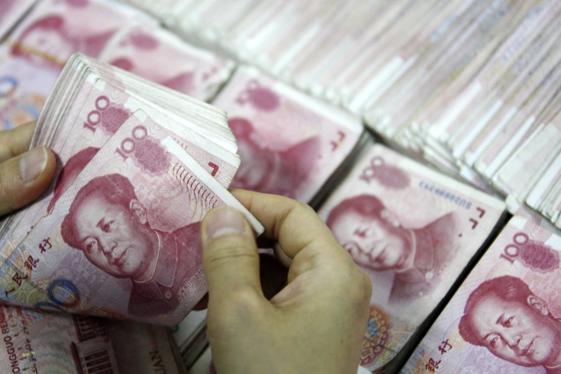 Stacks of yuan are counted at a bank in China as the currency has apparently stabilized after falling the past three days following a surprise devaluation earlier in the week. Photo: AFP