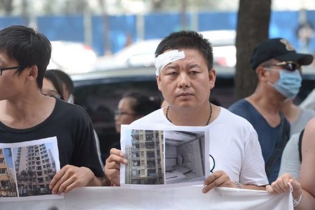 Frustrated owners from the Qihang Jiayuan residential compound demonstrate outside a press briefing. File Photo