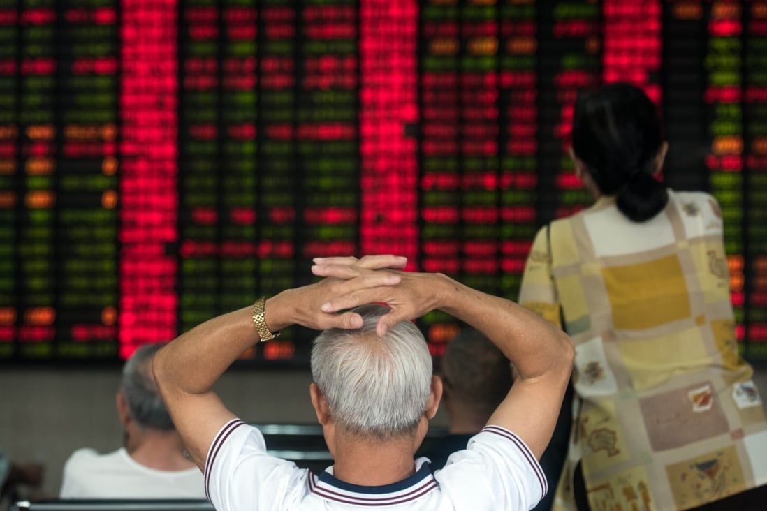 An investor watches anxiously the movement of share prices in Shanghai, China. Photo: AFP  