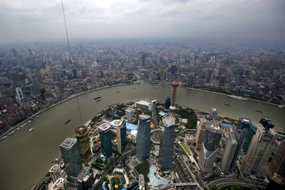 A general view of Shanghai's financial district of Pudong is seen from the top of the Shanghai Tower, as China Overseas Land & Investment Limited said it would consider swaps to hedge against yuan depreciation risks. Photo: Reuters 