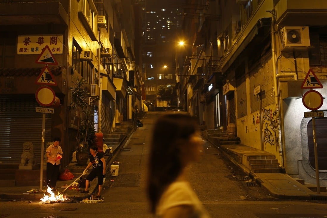 Two women burning hell money during the Hungry Ghost Festival in Hong Kong. Photo: Vincent Yu