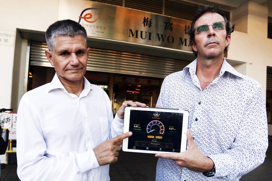 Lantau residents Robert Clark (left) and Merrin Pease display the slow internet speeds in Mui Wo using an iPad. Clark set up the group Islands Broadband Concern to push for a better service. Photo: Jonathan Wong