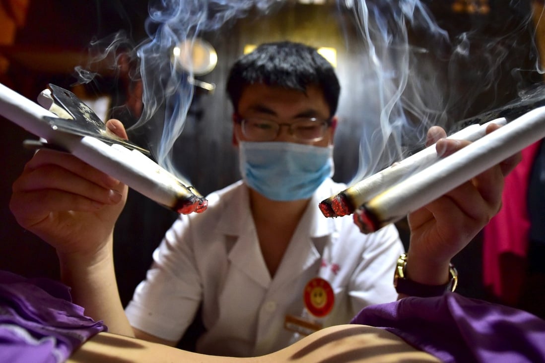 A therapist applies traditional moxibustion treatment on a patient in Yiwu, Zhejiang province. Chinese patients often use a mixture of Western and traditional Chinese medicine. Photo: Reuters