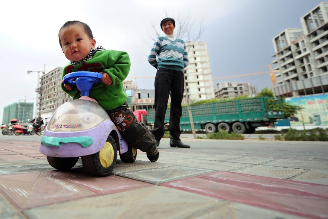 A child plays on a street in China's Inner Mongolia as developer Xinming China, which just went public in Hong Kong in July, is aiming to build itself into the first children-oriented company listed in the city. Photo: AFP
