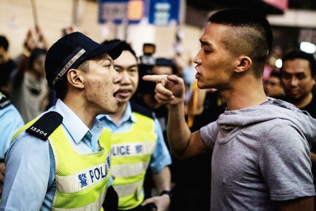 Police in Hong Kong have been accused in the past of failing to crackdown on triad activities. This file photo shows a typically tense scene between a police officer and a possible gang member. Photo: SCMP Pictures