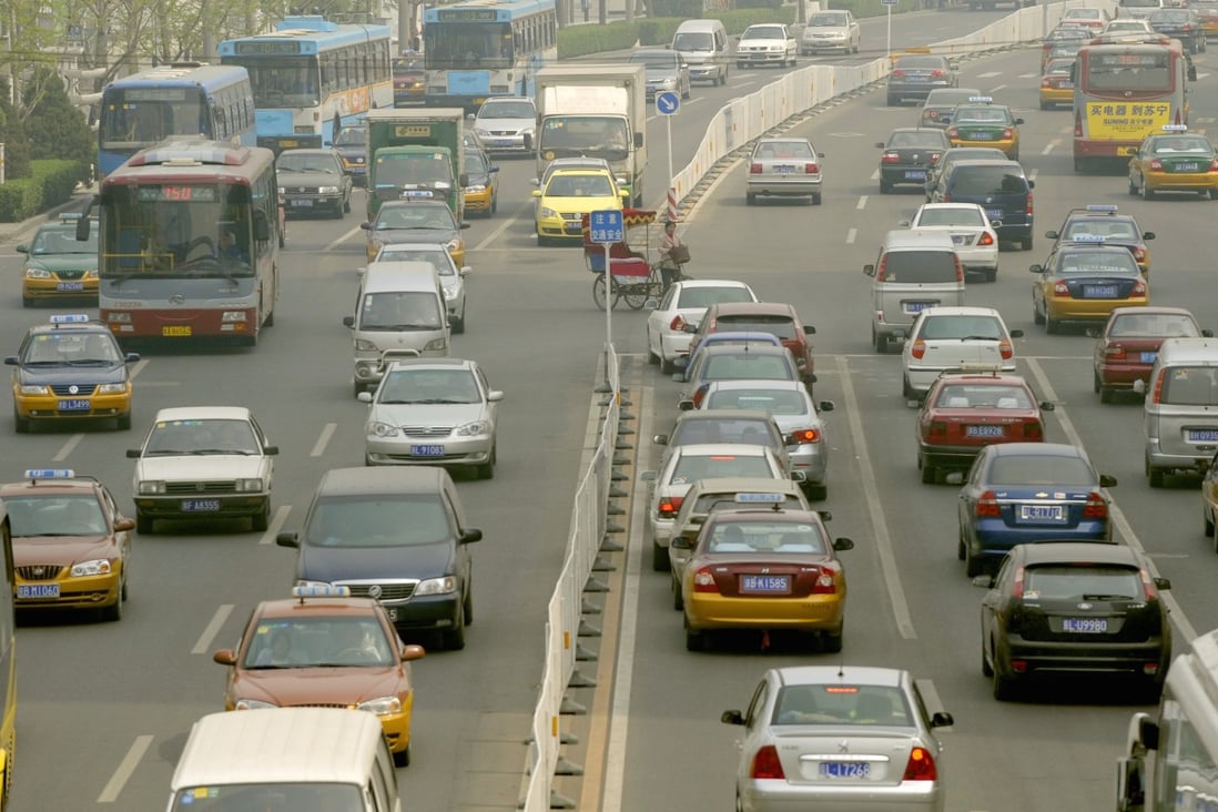 Cars jam the streets in rush-hour traffic in Beijing. Meanwhile, a weakening economy prompted Fitch to cut its forecast for global economic growth in 2015. Photo: AFP