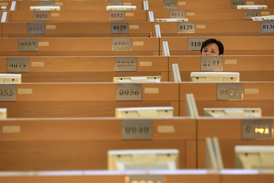 A trader looks up from his work station at the Shanghai Stock Exchange. Photo: Reuters