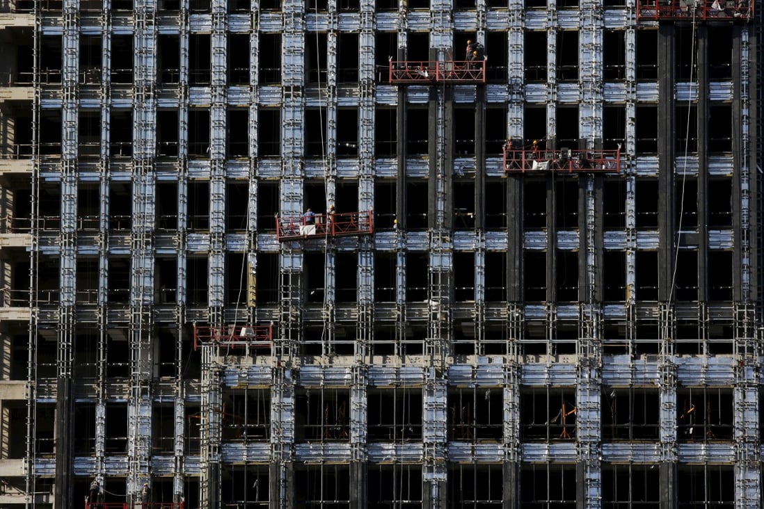 Labourers work on a new residential complex in Beijing in this file photo. The private equity arm of BlackRock is ready to increase its exposure to Chinese commercial real estate. Photo: Reuters
