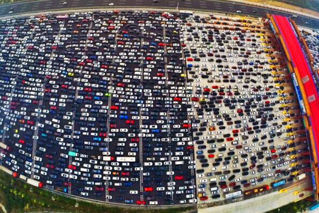 A bird's-eye view of vehicles as motorists queue up to pass through a road toll as they head into Beijing on Tuesday. Photo: SCMP Pictures