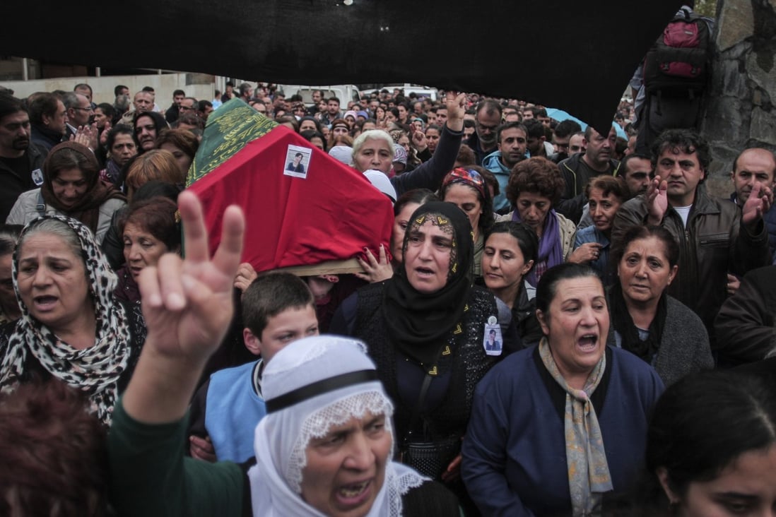 Mourners carry the coffin of Sarigul Tuylu, 35, a mother of two that was killed in Saturday's bombing attacks in Ankara. Photo: Photo: AP