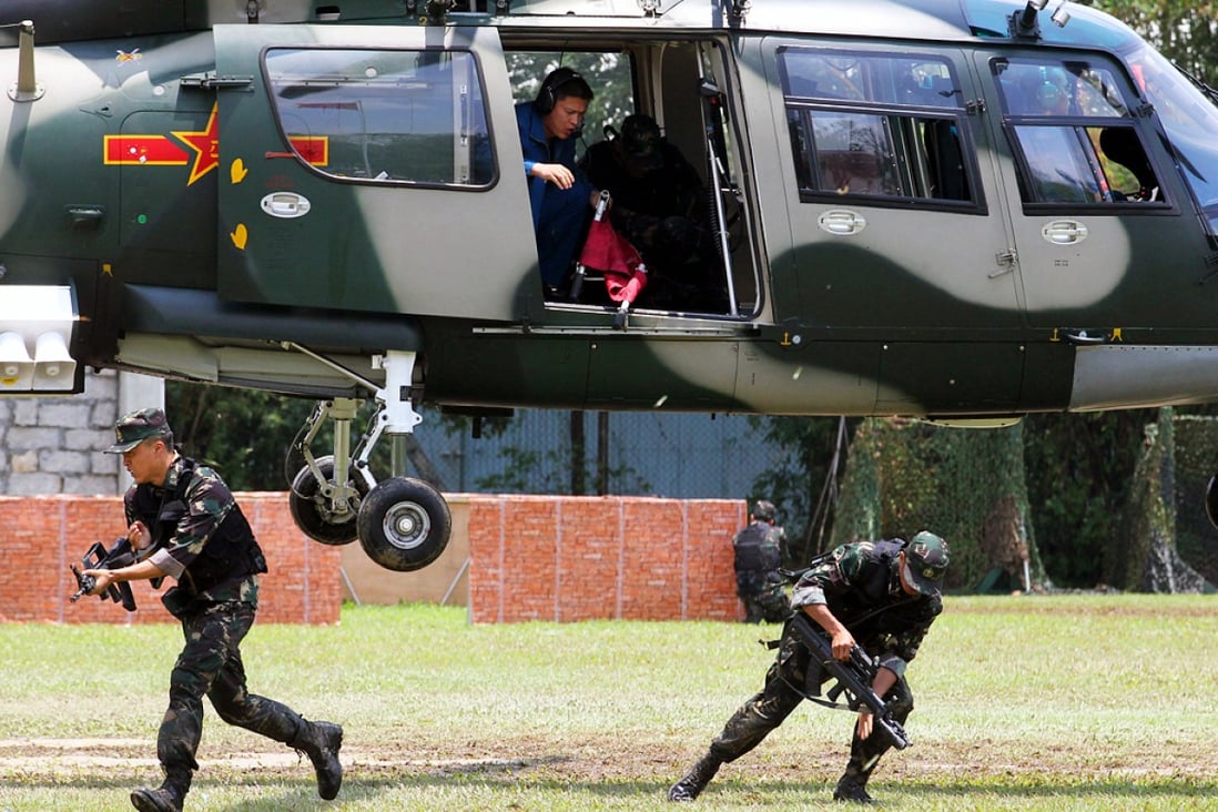 Soldiers of the People's Liberation Army Hong Kong Garrison demonstrate the rescue of an injured comrade by helicopter in an anti-terrorism operation during a PLA garrison open day at Shek Kong. Photo: Nora Tam