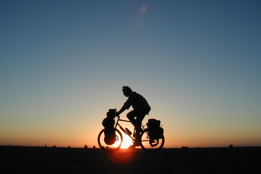 Cycling at sunset in Sudan. Photo: Alastair Humphreys