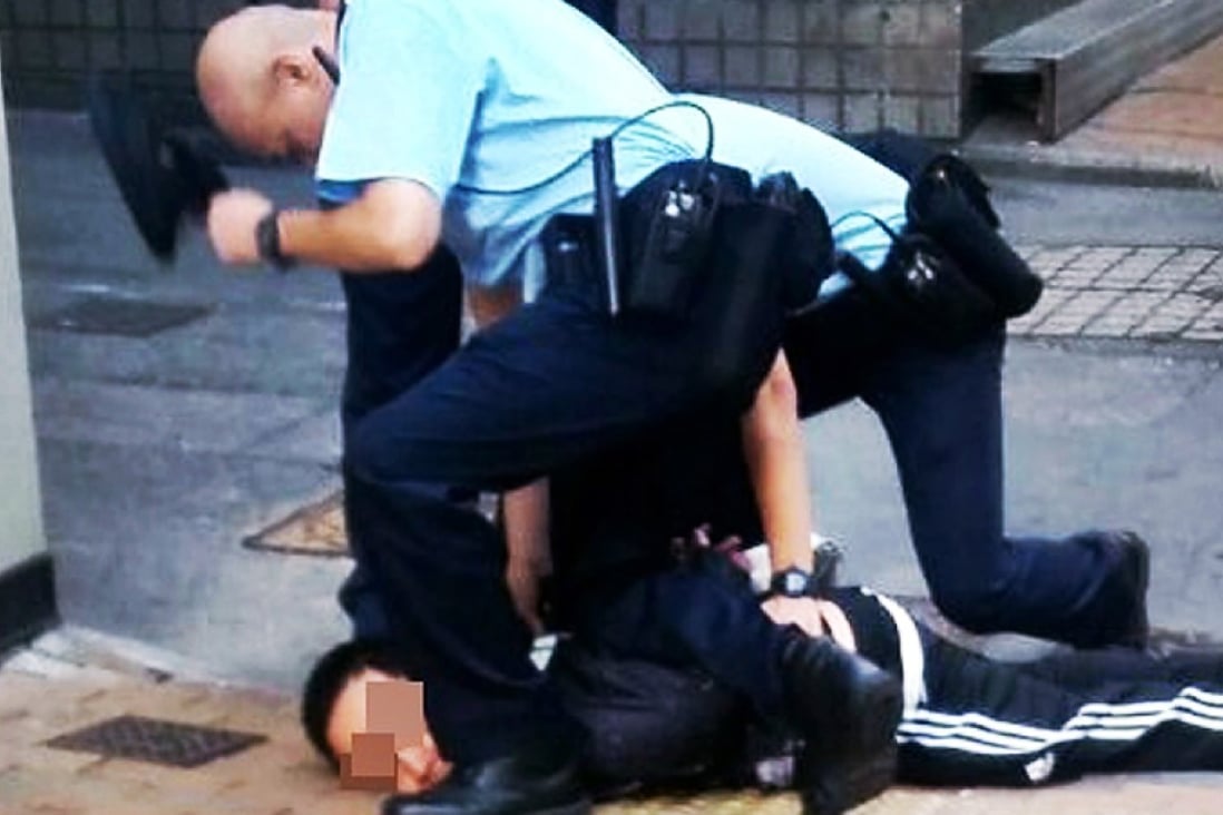 Police officers subdue the suspect. Photo: SCMP Pictures