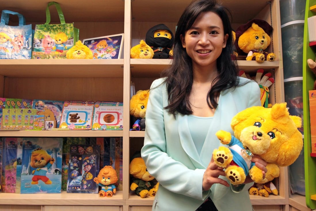 Businesswoman Poman Lo poses with her creations - the Bodhi dolls. Photo: Bruce Yan
