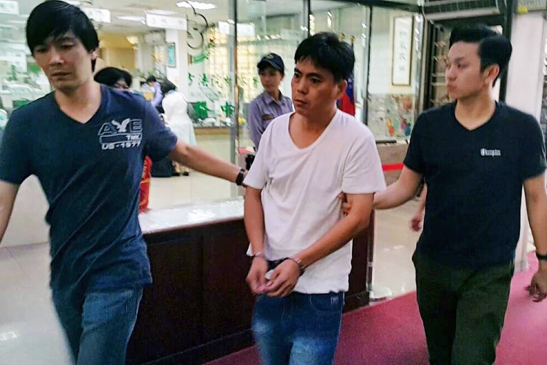 One of the two suspects in Hong Kong businessman Taiwan kidnap case brought to police station. Photo: SCMP Pictures