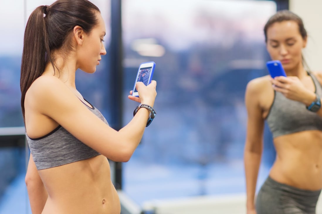 These days, everyone seems to be glued to their phones in the gym. Photo: Shutterstock