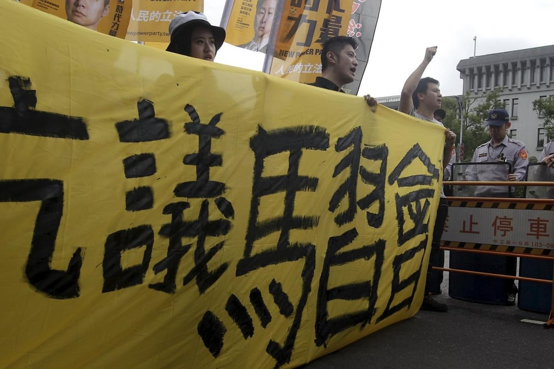 Activists in Taipei protest against the meeting. Photo: Reuters