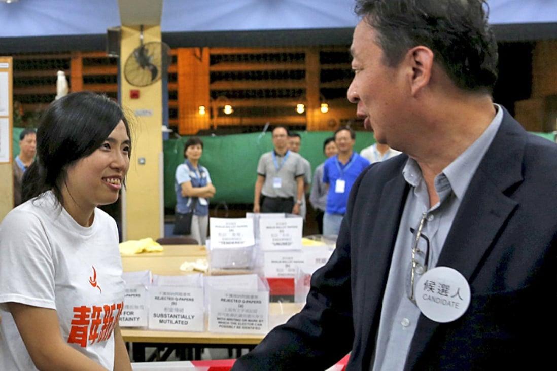 Kwong Po-Yin (left), member of ‘Umbrella soldier’ group Youngspiration, shakes hands with district council election candidate Lau Wai-Wing (right), after Kwong won a district council election at Whampoa West in Hong Kong. Reuters