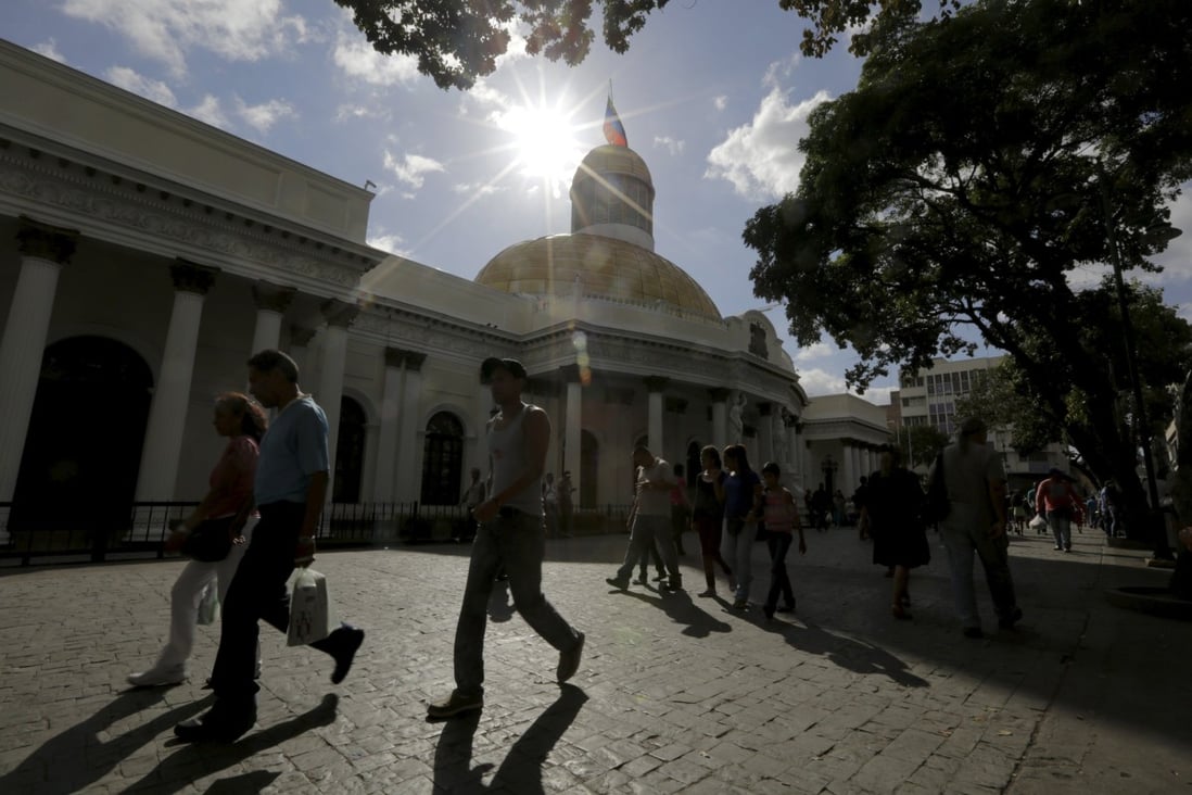 People walk past the National Assembly building in Caracas. Venezuela is the riskiest destination for Chinese to invest, according to a study by a Chinese government think tank. Photo: Reuters