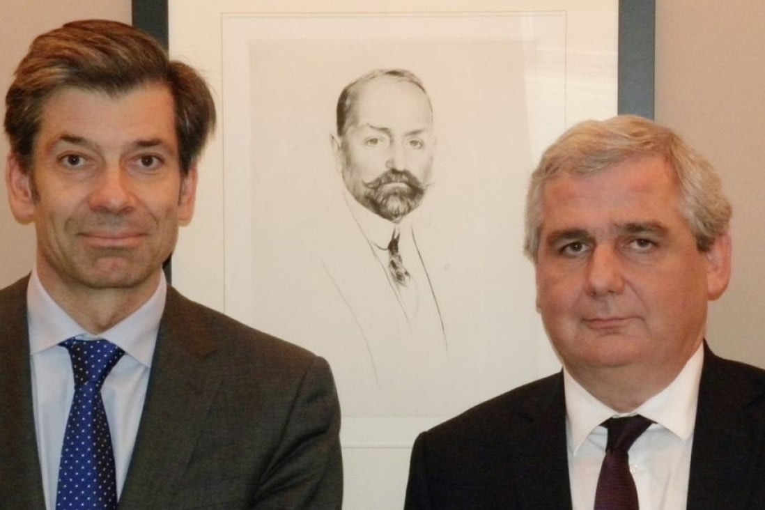 (From left) Tom van Lambaart, chief operating officer, and Stéphane Marnier Lapostolle, supply chain director, stand in front of a portrait of Grand Marnier's creator, Louis-Alexandre Marnier Lapostolle.