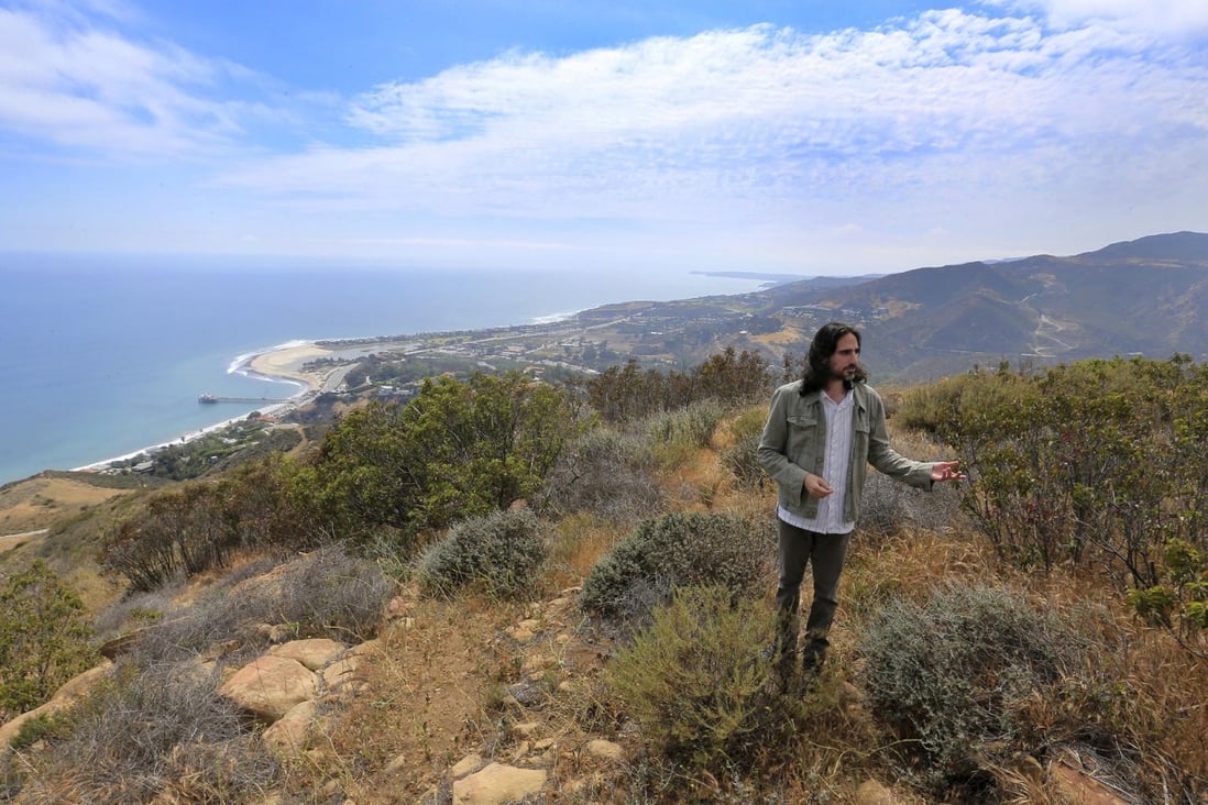 Project director Moses Hacmon on the hillside where The Edge planned to build a home. Photos: Los Angeles Times; AFP; Reuters