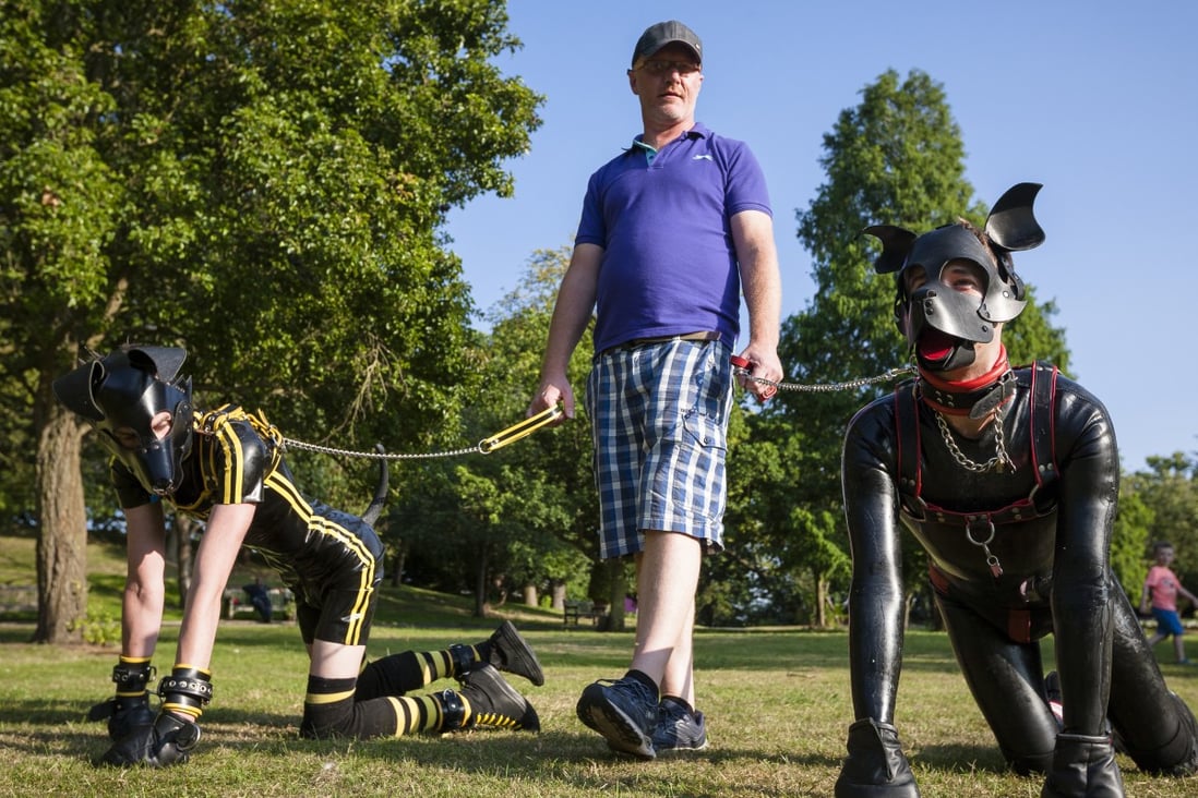 Andy, a handler, walks Scamp (right) and another pup in Croydon, south London. Pictures: Erik Messori