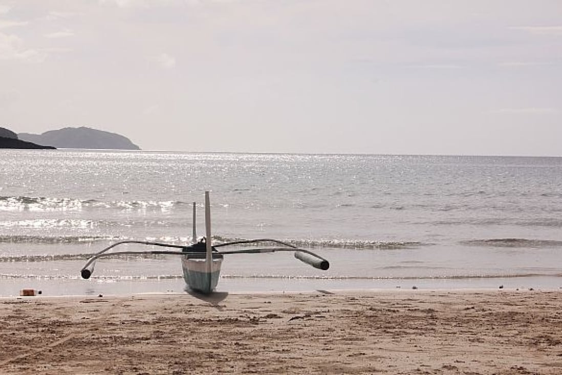 A boat and a beach in the island province of Palawan in the Philippines. 