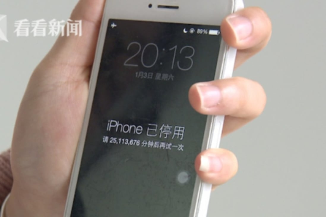 A woman in China holds an iPhone that says it’s been disabled for more than 25 million minutes (Source: Kankanews.com)