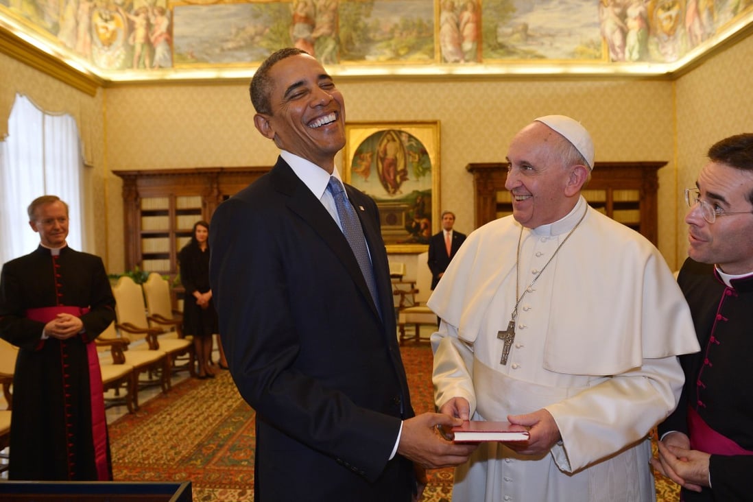 Barack Obama and Pope Francis exchange gifts at the Vatican in March. Photo: AFP