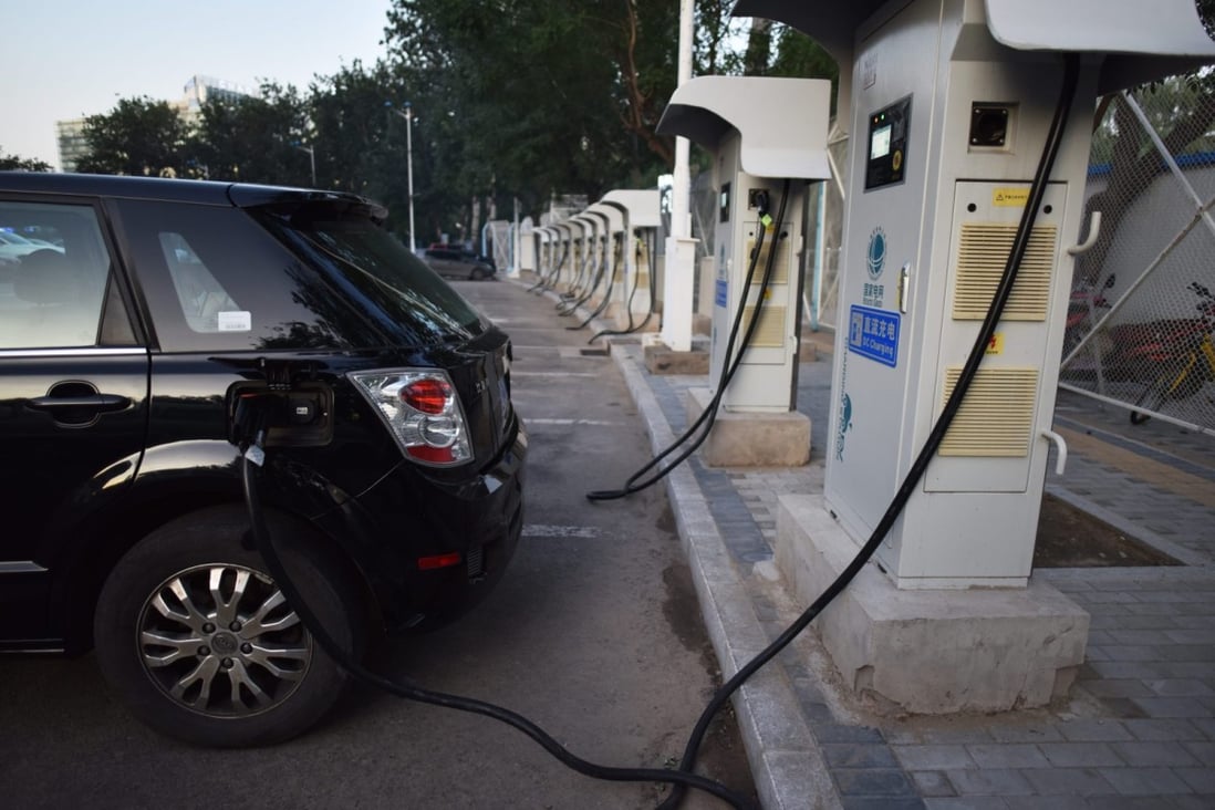 An electric car plugs in at a charging station in Beijing on September 11, 2017. (Picture: Greg Baker/AFP)