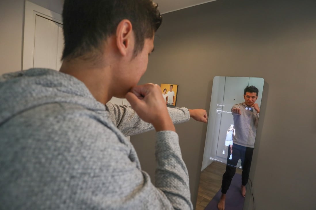 Keith Rumjahn, CEO and founder of OliveX, maker of the Kara Mirror, works out in his home. Photo: Jonathan Wong