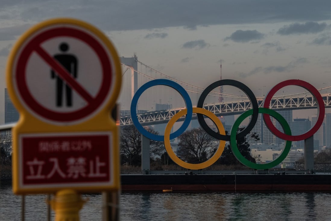 A warning sign near the Olympic Rings in Tokyo, Japan. There will be strict entry protocols, similar to those for the current handful of travellers going to Japan, for athletes at the Olympic Games. Photo: Getty Images 