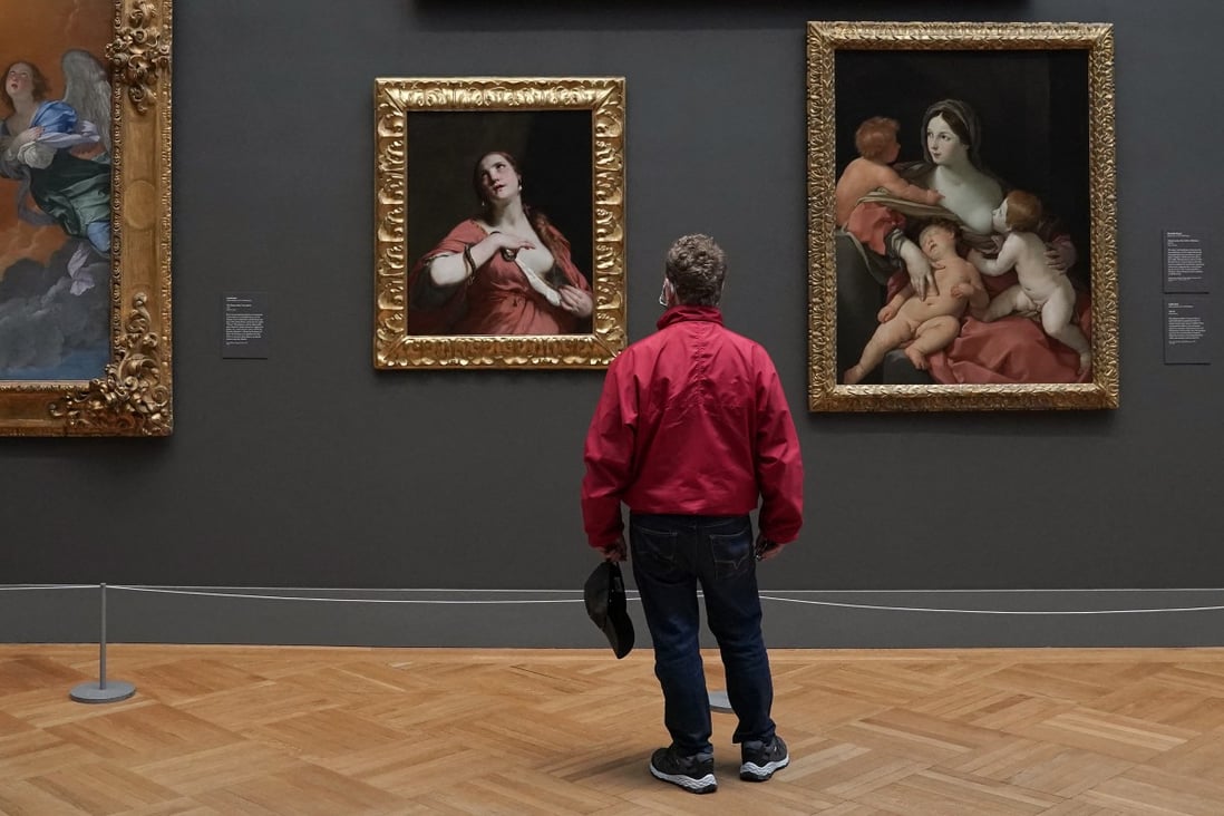 A patron looks at paintings on display at the Metropolitan Museum of Art in New York. With on-site visits halted, the museum is offering virtual tours of its collections. Photo: AFP