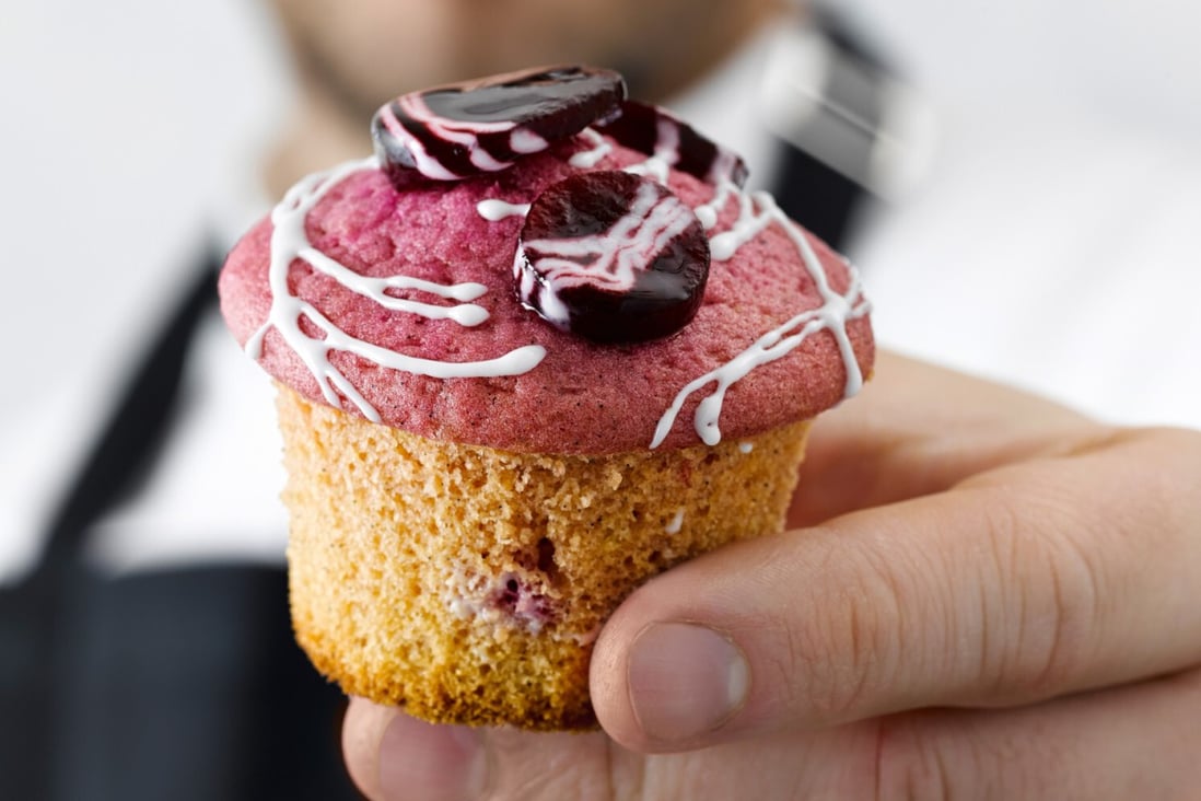 Pastry chef Christian Huembs with one of his beetroot and white chocolate muffins. Photo: Jan C. Brettschneider/DK Verlag/DPA