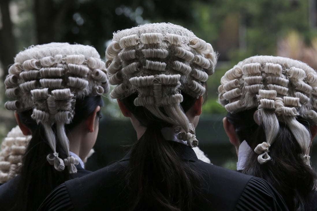 Barristers pose for a group photo after an appointment ceremony for senior counsel outside the Court of Final Appeal building in Hong Kong on June 22, 2019. Photo: Associated Press