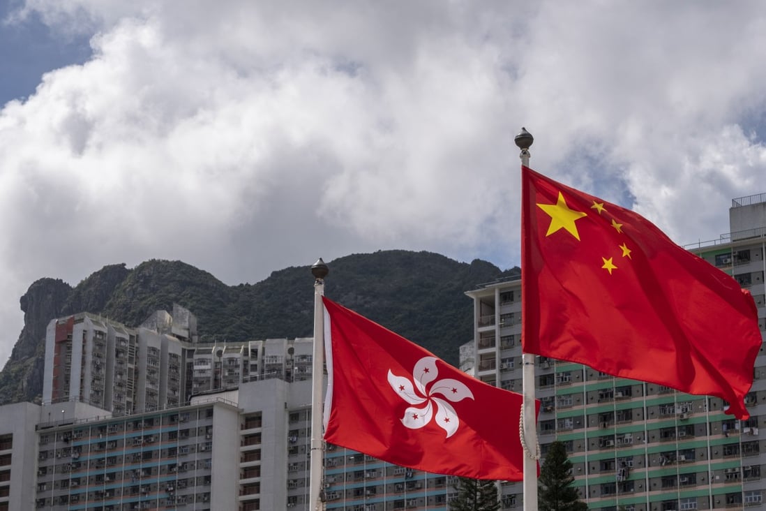 The Hong Kong and Chinese national flags are seen against the backdrop of Lion Rock mountain, symbolic of the city’s “can do” spirit. Photo: Sun Yeung