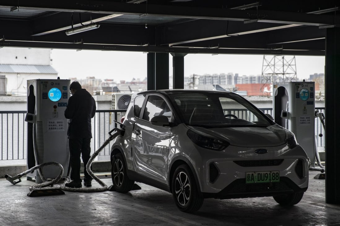 A person charges his vehicle at a Beijing Jingneng Clean Energy Co. charging station in Beijing, China, on Saturday, March 6, 2021. China, the world’s biggest car market, aims to boost auto sales and add more charging facilities for electric vehicles this year. Photographer: Qilai Shen/Bloomberg