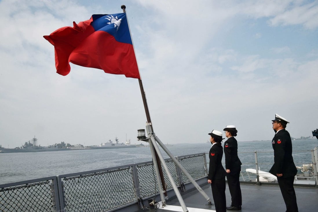 Taiwanese sailors salute the island’s flag on the deck of the Panshih supply ship after taking part in annual drills, at the Tsoying naval base in Kaohsiung, in January 2018. Photo: AFP 