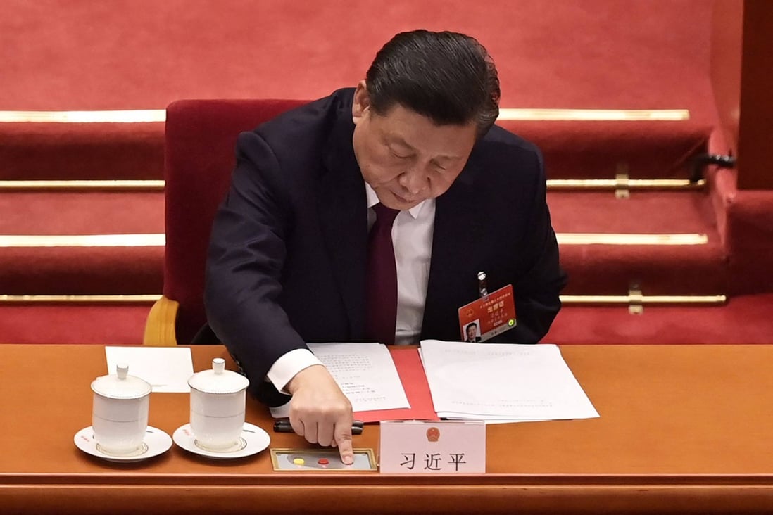 President Xi Jinping votes on changes to Hong Kong’s election system during the closing session of the National People’s Congress at the Great Hall of the People in Beijing on March 11. Photo: AFP