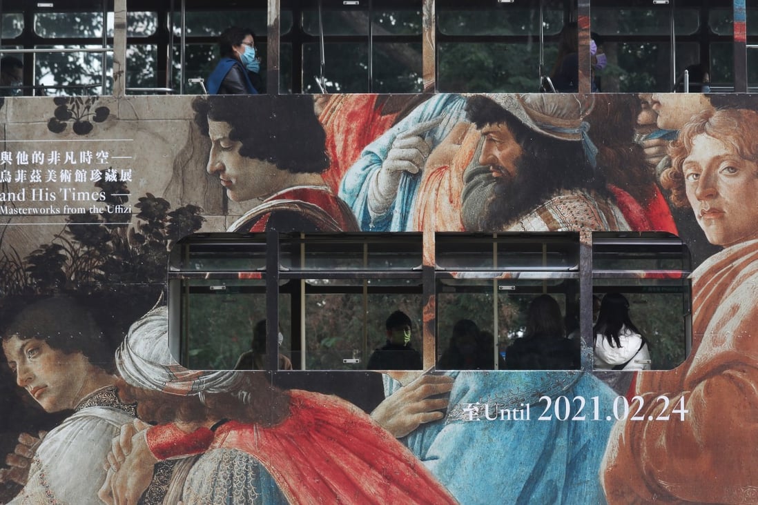 People travel on a tram covered in an ad for the “Botticelli and His Times” exhibition at the Hong Kong Museum of Art in December 2020. Photo: Xiaomei Chen